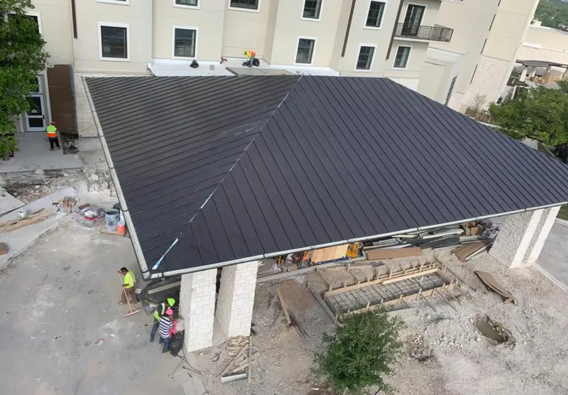 Metal roofing installation team working on a commercial building in Decatur